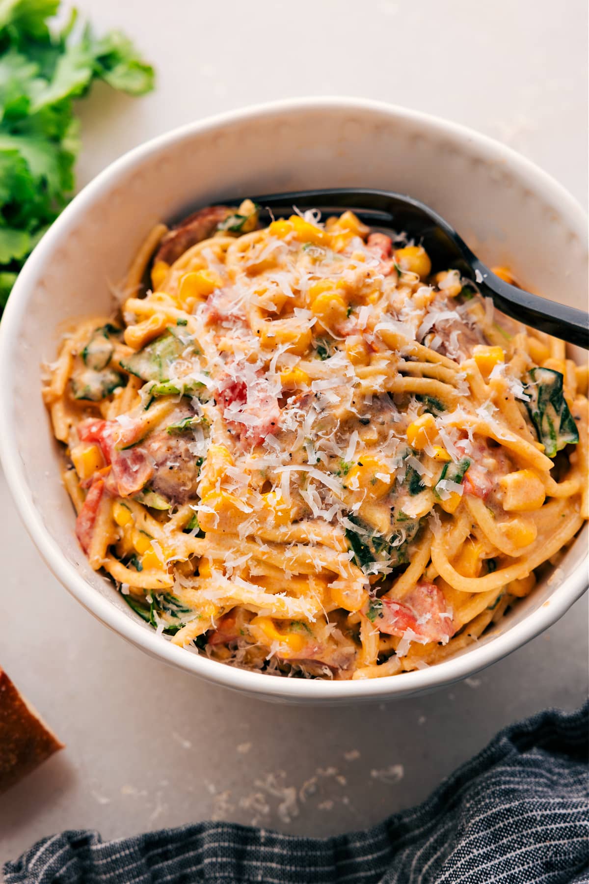 Vibrant Corn And Sausage Pasta Recipe Corn and Sausage Pasta topped with parmesan in a bowl.
