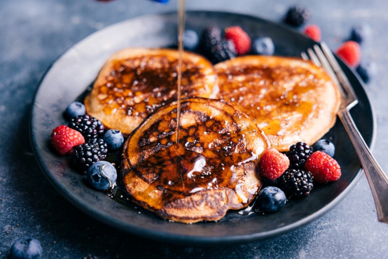 Image of the healthy pancakes with syrup being poured on them