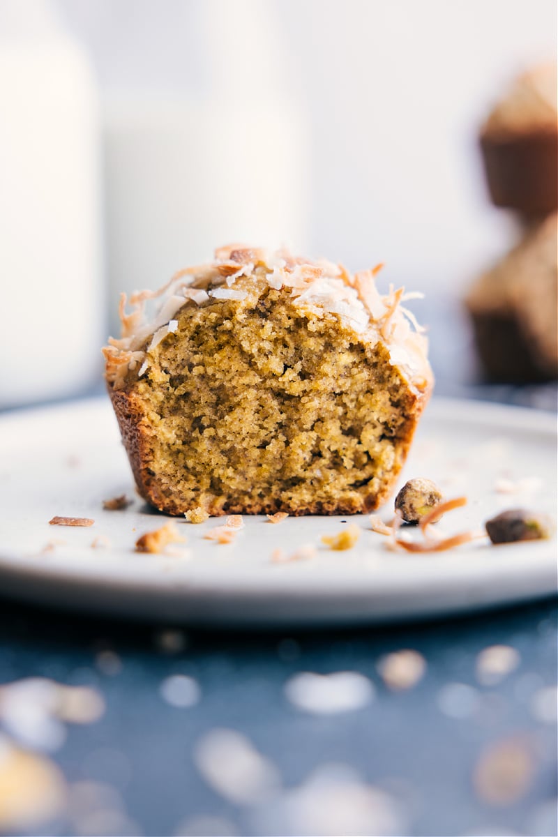 Image of one muffin on a plate with a bite out of it