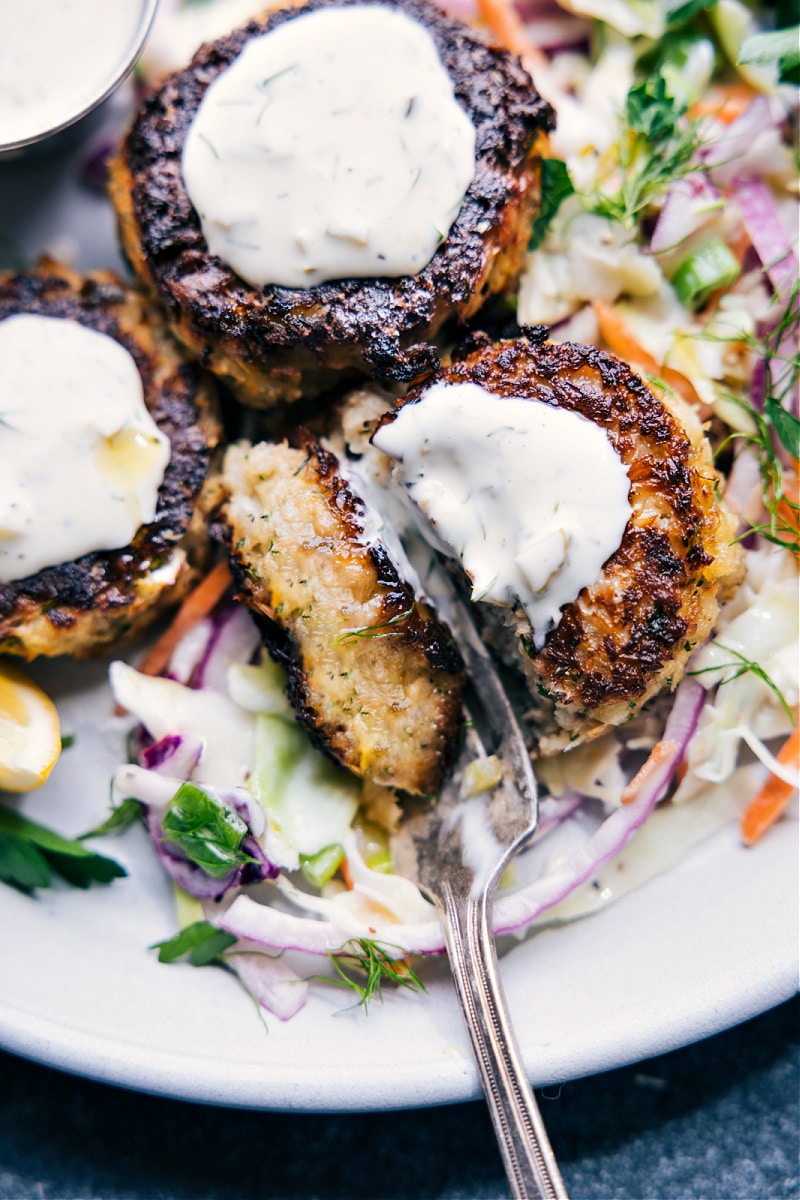 Overhead image of Tuna Patties on a bed of cole slaw with tartar sauce on top