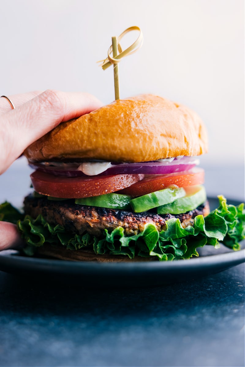 This is the best Veggie Burger recipe ever! With loads of veggies, beans, and cashews you'll be amazed how "meaty" these burgers taste -- sure to thrill the vegetarians AND even the biggest carnivores! Recipe via ChelseasMessyApron.com #veggieburger #vegetarian #burger #meatless #beans #cashews #panko #healthy Veggie Burger with all the trimmings