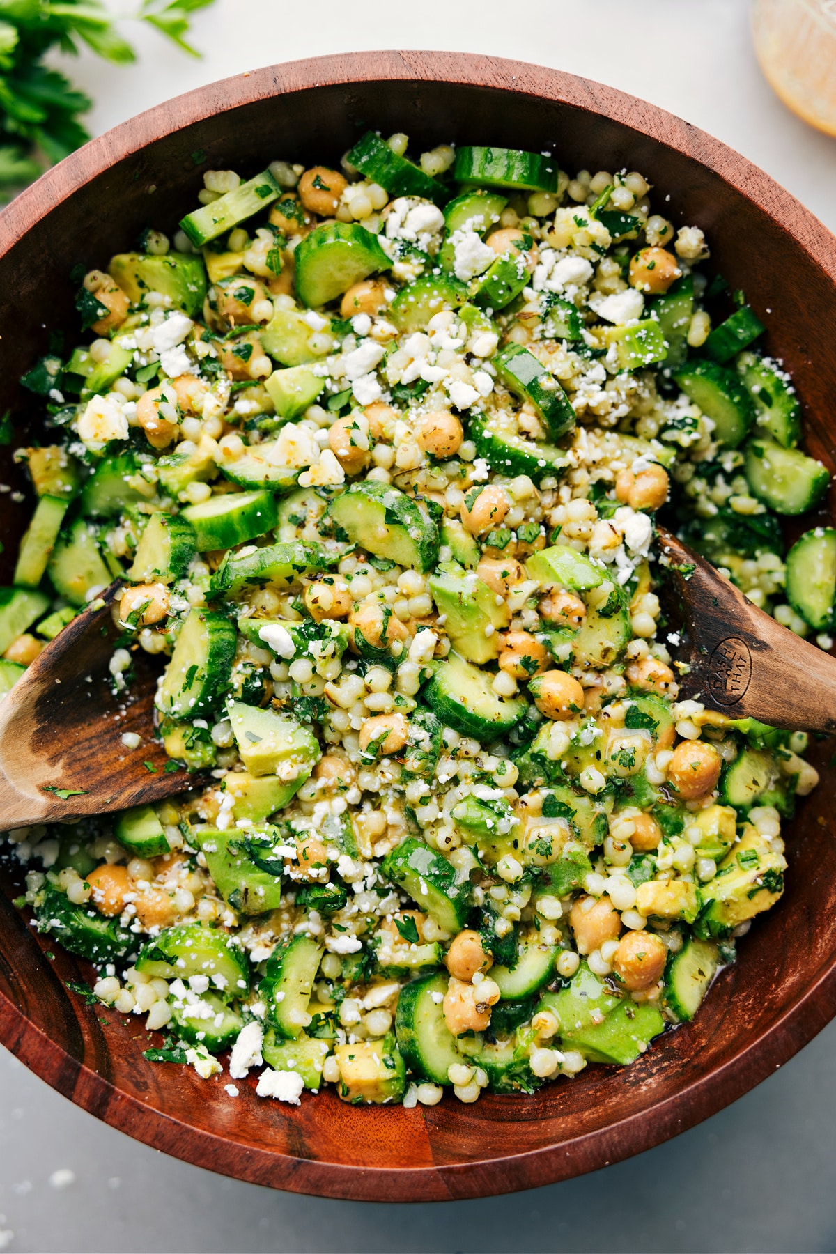 Cucumber feta salad tossed with dressing and ready to be served.