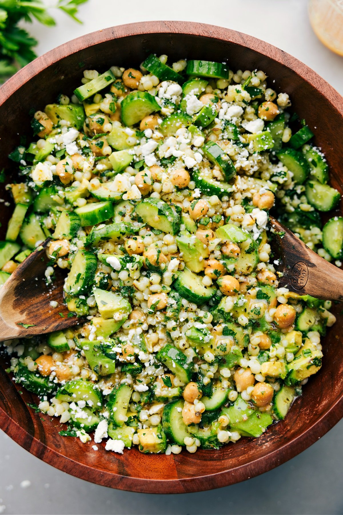 Cucumber feta salad tossed with dressing and ready to be served.