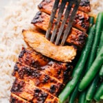 The easy blackened chicken recipe with a fork picking up a piece.