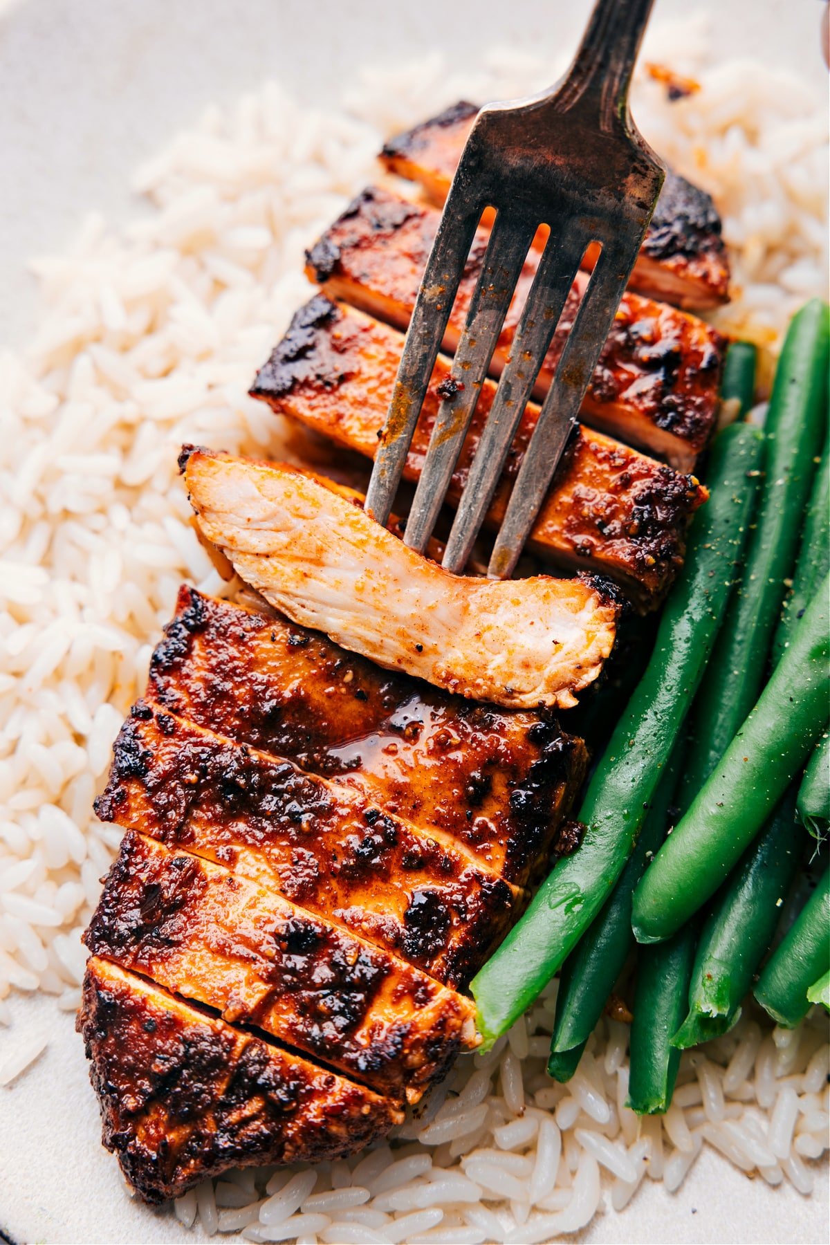 The easy blackened chicken recipe with a fork picking up a piece.