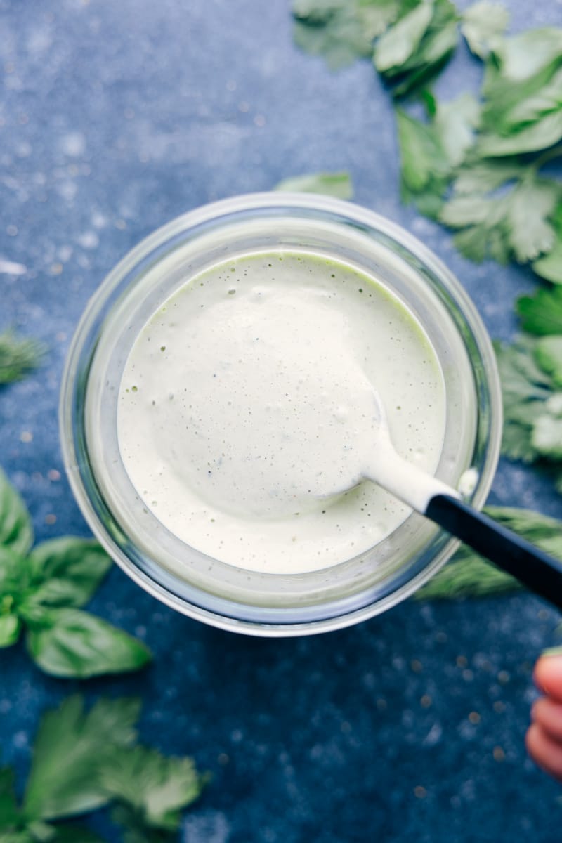 Overhead close-up view of a container full of Green Goddess dressing