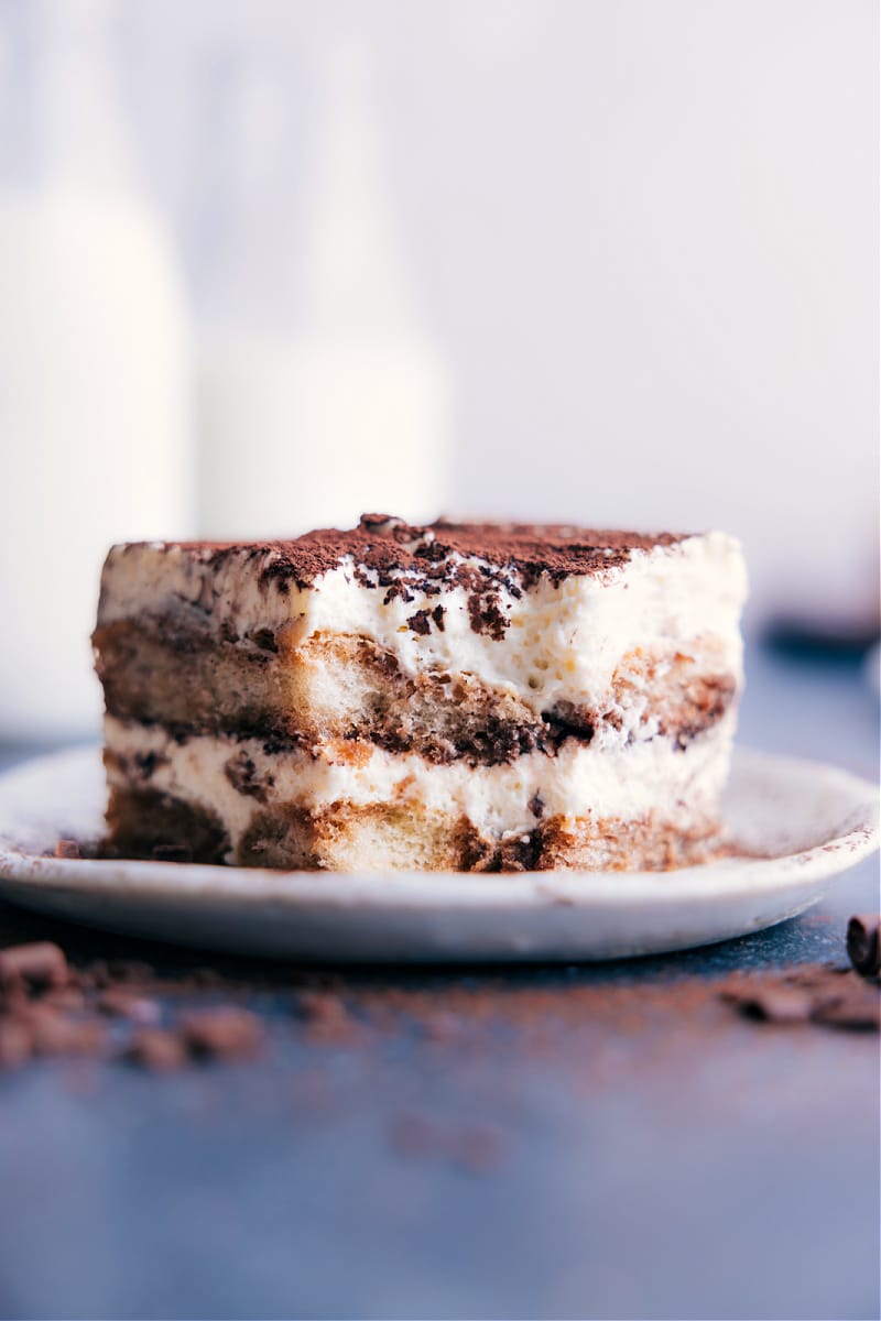 Image of a slice of Tiramisu on a plate with a bite out of it