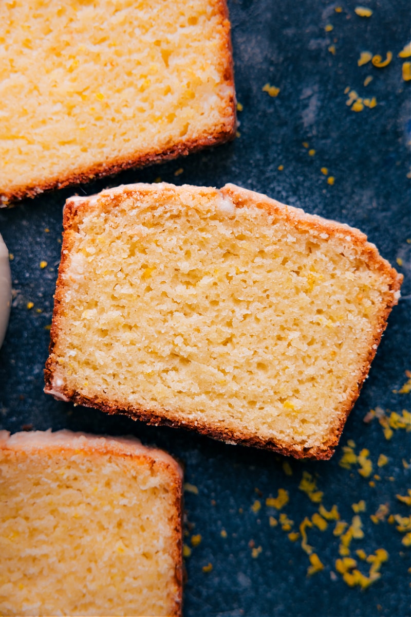 This Iced Lemon Bread is one for the books! Recipe via chelseasmessyapron #quickbread #breakfast #brunch #sweet #sweetbreakfast #lemon #bread Overhead image of a slice of the dessert bread