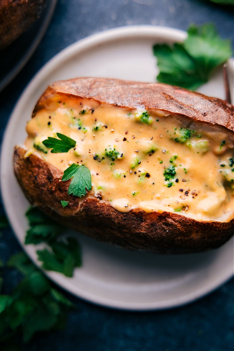 Up-close overhead image of the Broccoli and Cheese Baked Potatoes on a plate ready to be enjoyed!