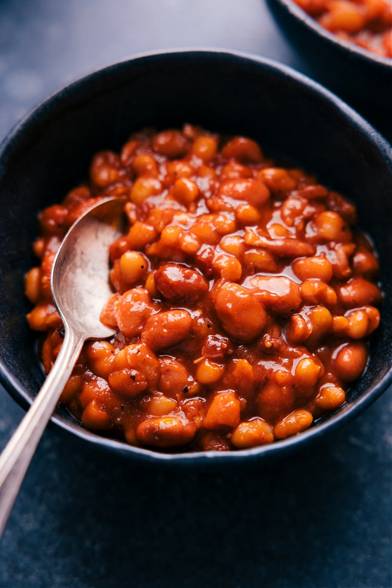 View of Baked Beans in a bowl with a spoon