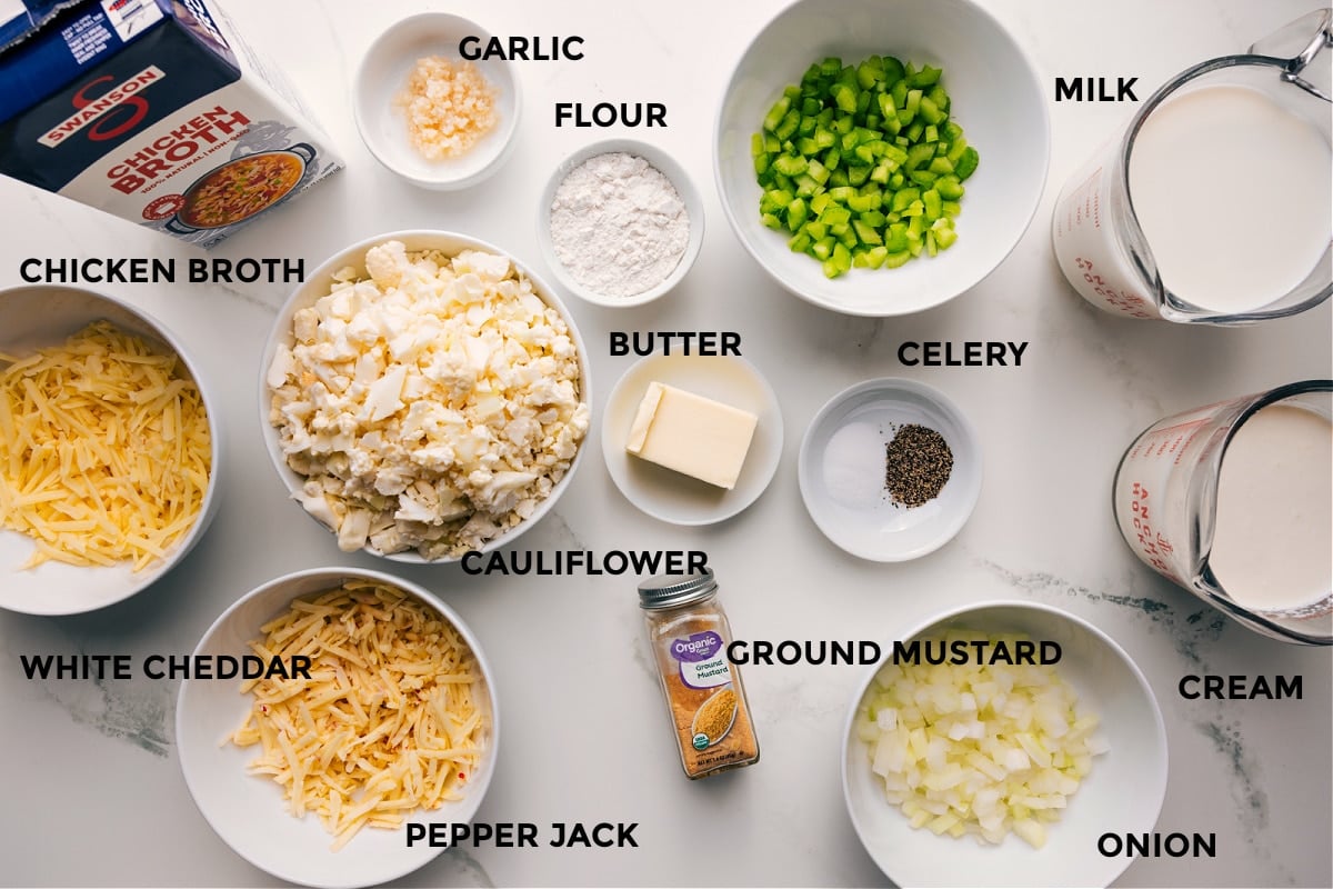 Ingredients In Cauliflower Soup Recipe All the ingredients in this recipe prepped out for easy assembly including the cheese, brother, cauliflower, garlic, flour, butter, seasonings, onion, cream, and milk.
