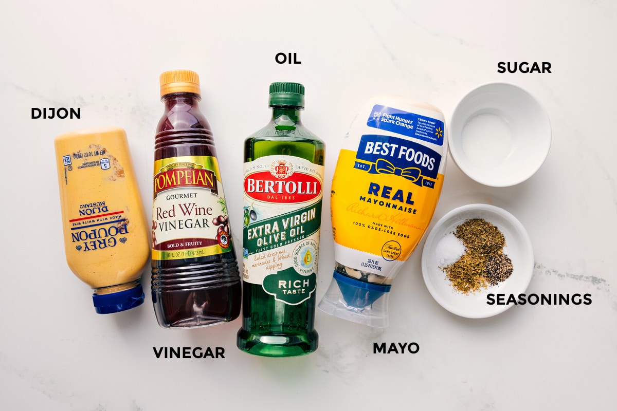 All the dressing ingredients in this Olive Garden salad recipe prepped out including the dijon, vinegar, oil, mayo, seasonings, and sugar.