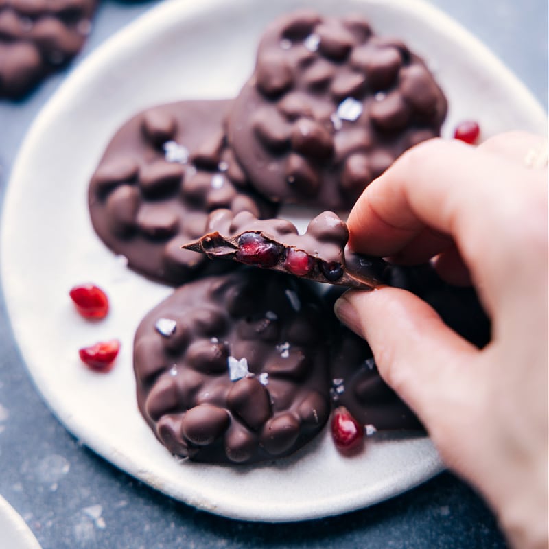Chocolate-Covered Pomegranate Cluster with a bite out of it