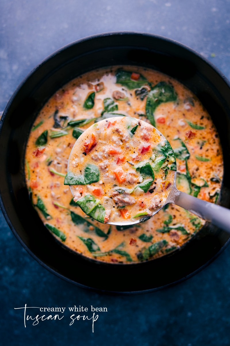 Overhead image of the Tuscan Soup in the pot with a ladle coming up filled with soup