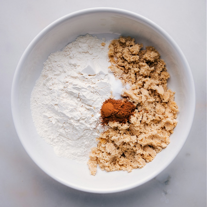 Process shot-- image of the flour, brown sugar, and spices added to a bowl