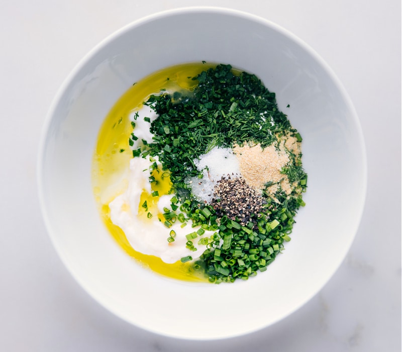 Process shots of Ranch Dressing-- image of the olive oil being added into the bowl with all the other ingredients