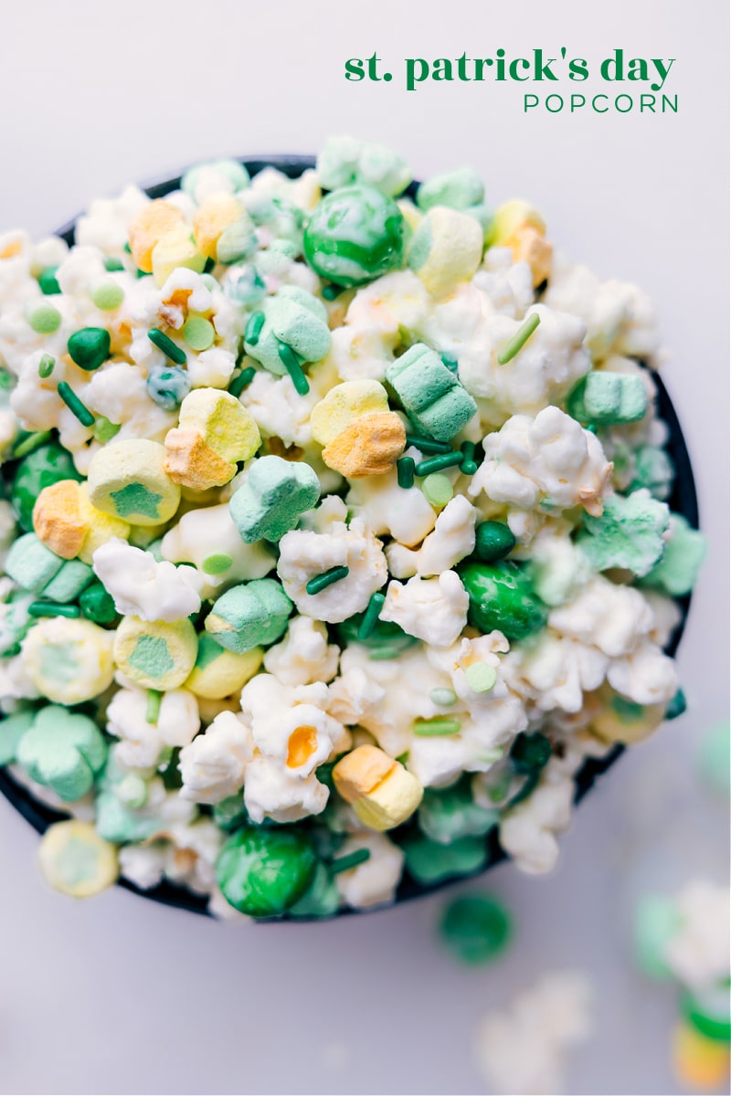 This delicious and easy-to-make St. Patrick's Day Popcorn recipe makes a fun and festive treat! We've got a mix of M&Ms, Lucky Charms Marshmallows, sprinkles, and popcorn all coated in white chocolate. This mix is a colorful and tasty snack that is perfect for sharing with friends and family. Whether you're planning a St. Patrick's Day party or just want a fun treat to enjoy at home, this recipe is sure to be a hit! Recipe via chelseasmessyapron #treat #best #quick #easy #simple #snack #stpatricks #stpatricksday #popcorn Overhead image of the St. Patrick's Day Popcorn