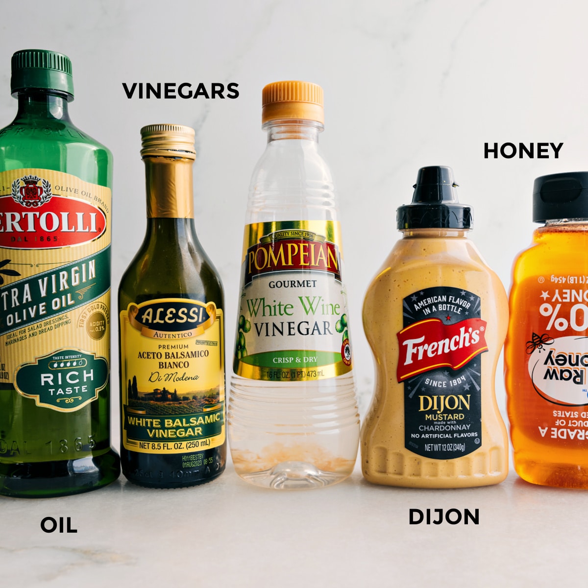 Ingredients In White Balsamic Vinaigrette Recipe All the dressing ingredients are prepped and ready to mix—olive oil, balsamic vinegar, white wine vinegar, Dijon, and honey.
