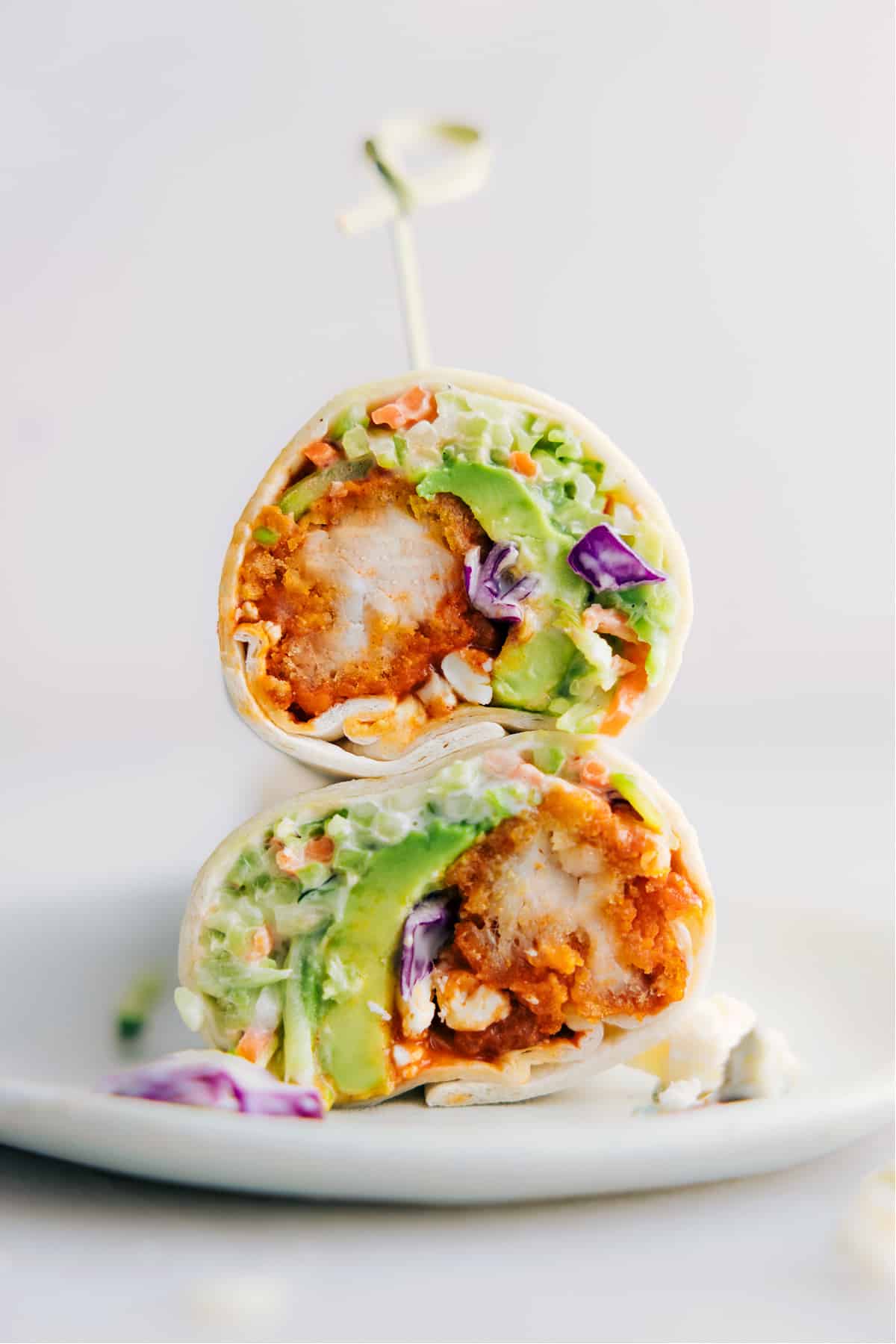 Buffalo Wraps Recipe Ready To Be Enjoyed Buffalo Chicken Wraps cut in half and stacked on top of each other ready to be enjoyed.
