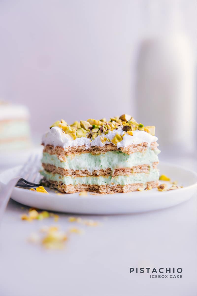This irresistible Pistachio Icebox Cake is made with layers of graham crackers and fluffy pistachio pudding, topped with whipped cream and crunchy pistachios, creating a perfect balance of sweet and nutty flavors with a creamy and smooth texture. This is an icebox cake, which means it's chilled in the refrigerator overnight, making it a convenient make-ahead dessert option. Recipe via chelseasmessyapron #dessert #best #quick #easy #simple #stpatricksday #treat #nobake #pistachio #icebox #cake Image of Pistachio Icebox Cake
