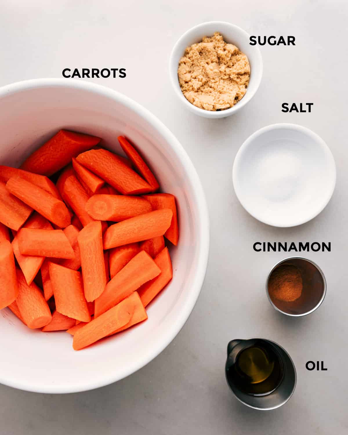 Ingredients in this recipe prepped out for easy assembly including sugar, salt, cinnamon, and carrots.