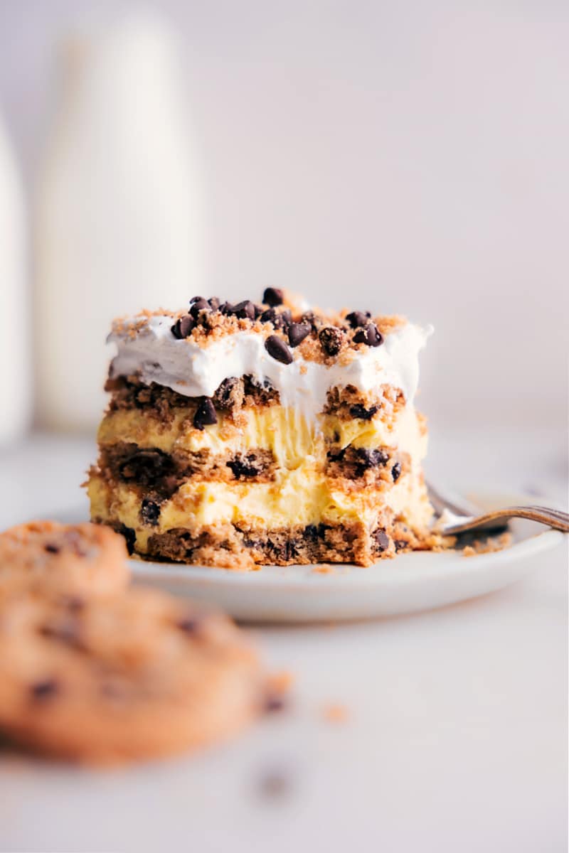 image of a slice of the Chocolate Chip Cookie Icebox Cake on a plate with a bite out of it