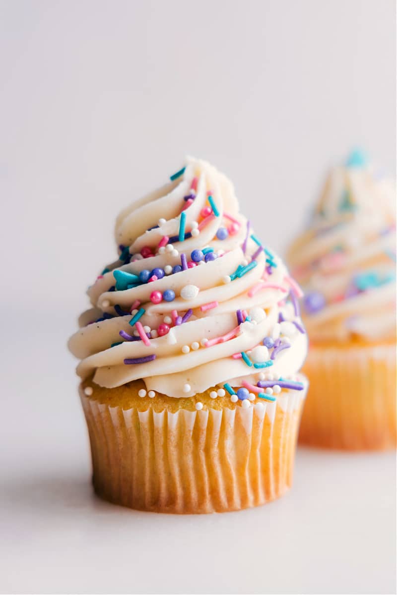 Image of a cupcake with Vanilla Frosting and sprinkles on it