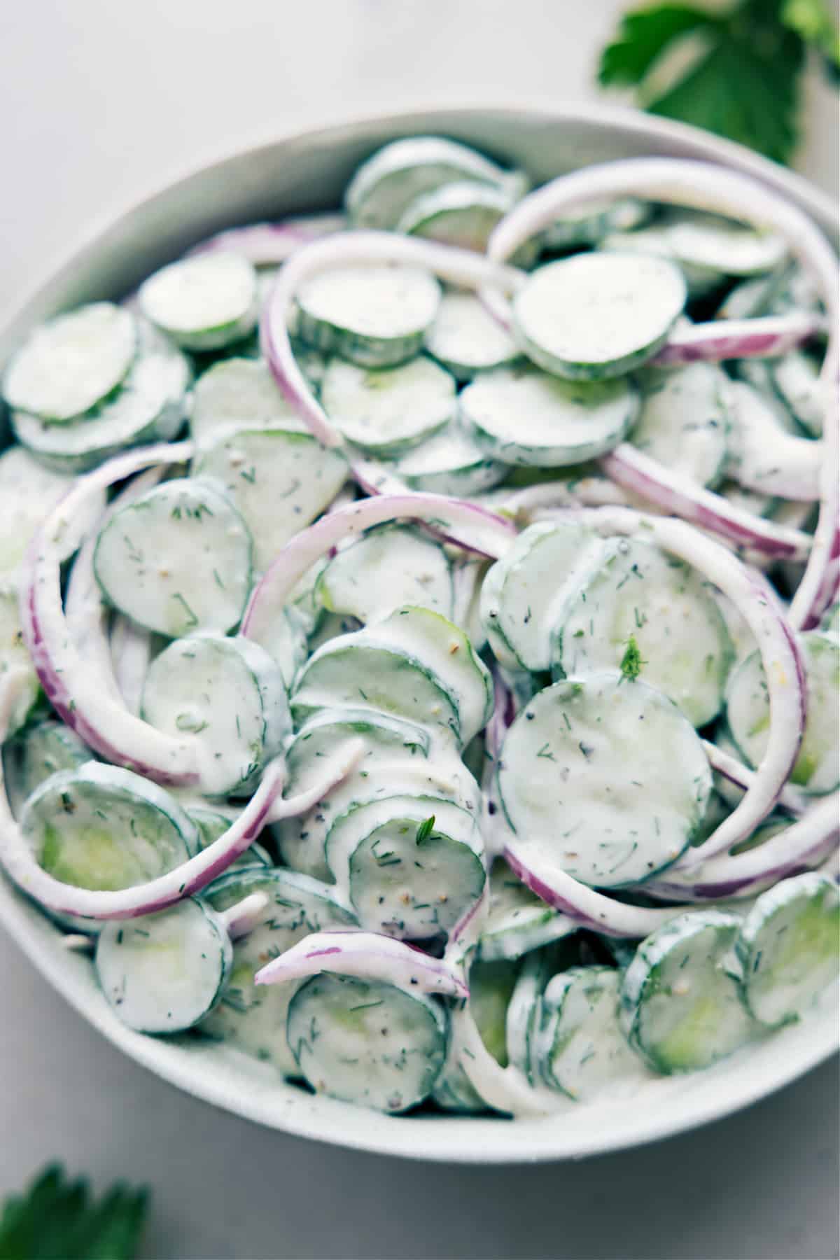 Creamy cucumber salad with sour cream in a bowl ready to be enjoyed.