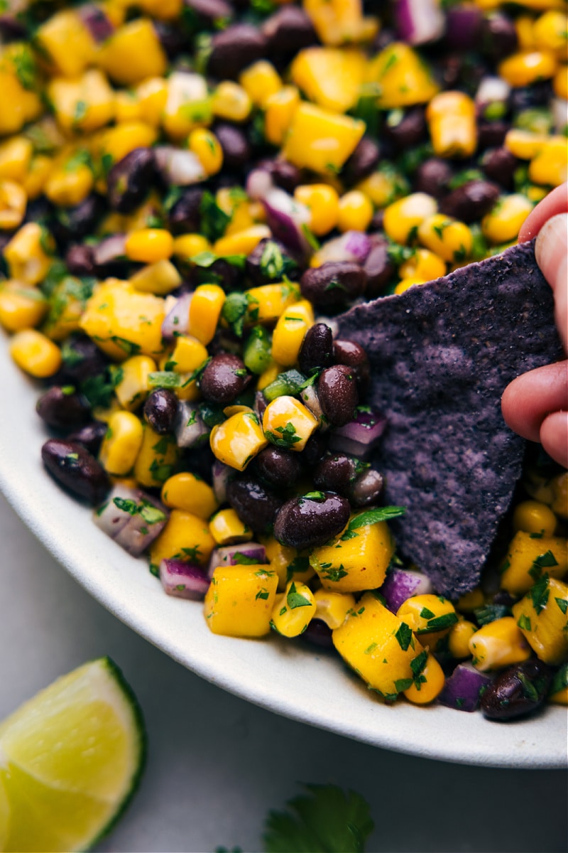 Image of a chip dipping into the Mango Black Bean Salsa