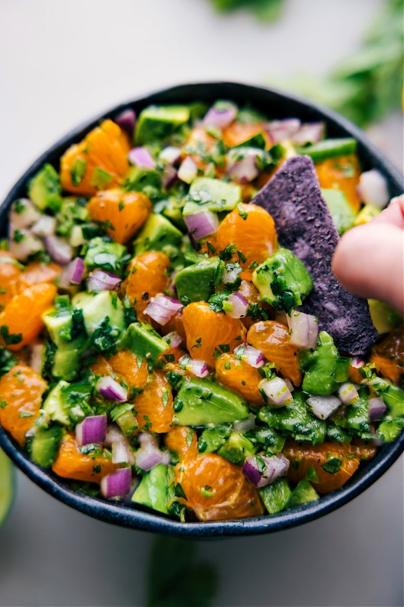 Overhead image of a chip dipping into the Avocado-Orange Salsa