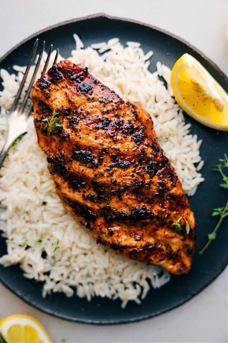 Overhead view of grilled chicken on a bed of white rice