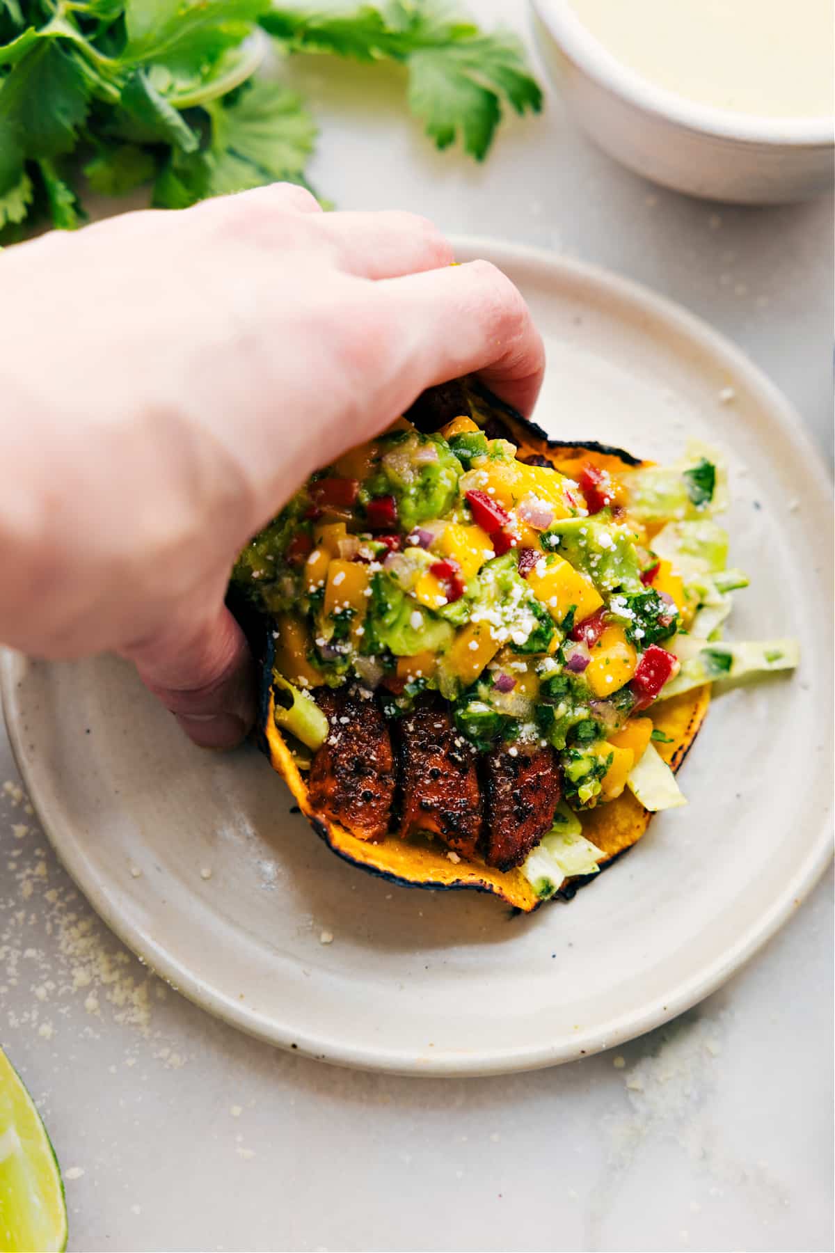 The Best Salmon Tacos Recipe Salmon Tacos on a plate with all the toppings.