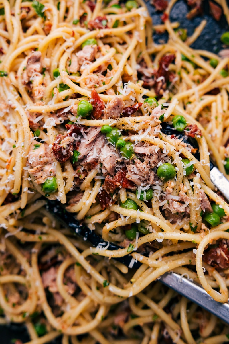 A bowl of healthy tuna pasta, freshly prepared and topped with grated cheese, inviting a savory and nutritious meal experience.