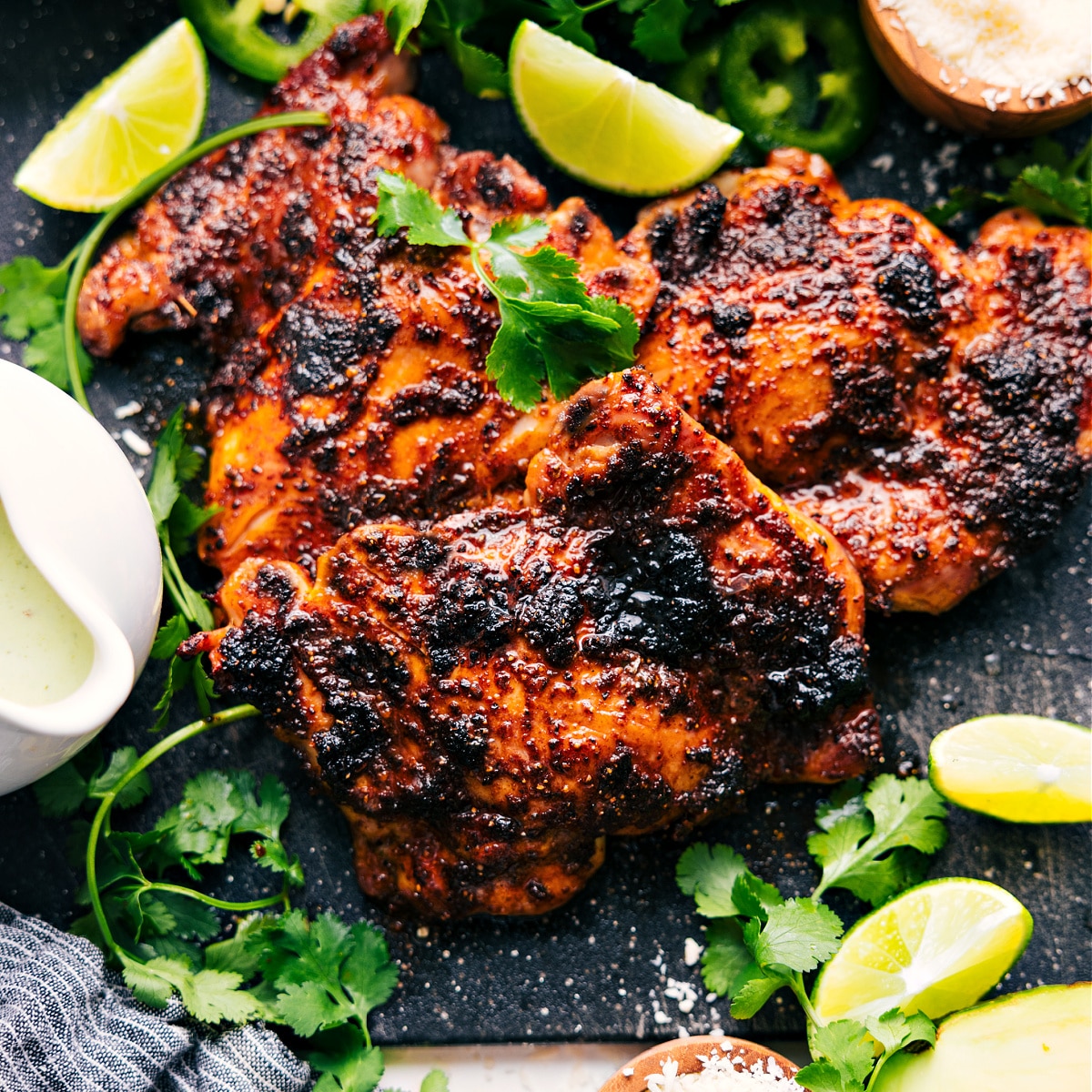 One Pan, Broiled Chipotle Chicken Recipe The meat fresh out of the oven with fresh limes, jalapeños, and cilantro to serve with.