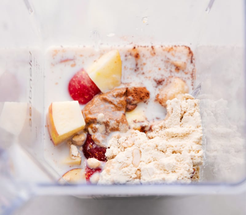 Overhead view of a blender full of Apple Smoothie ingredients.