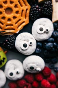 Donuts decorated to resemble ghosts, a Halloween breakfast idea.