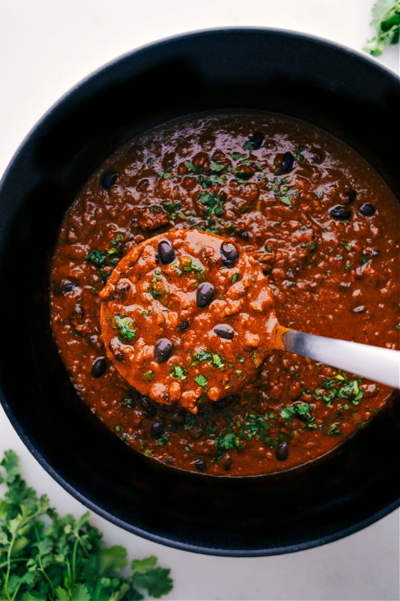 Overhead view of Pumpkin Chili with a ladle full.