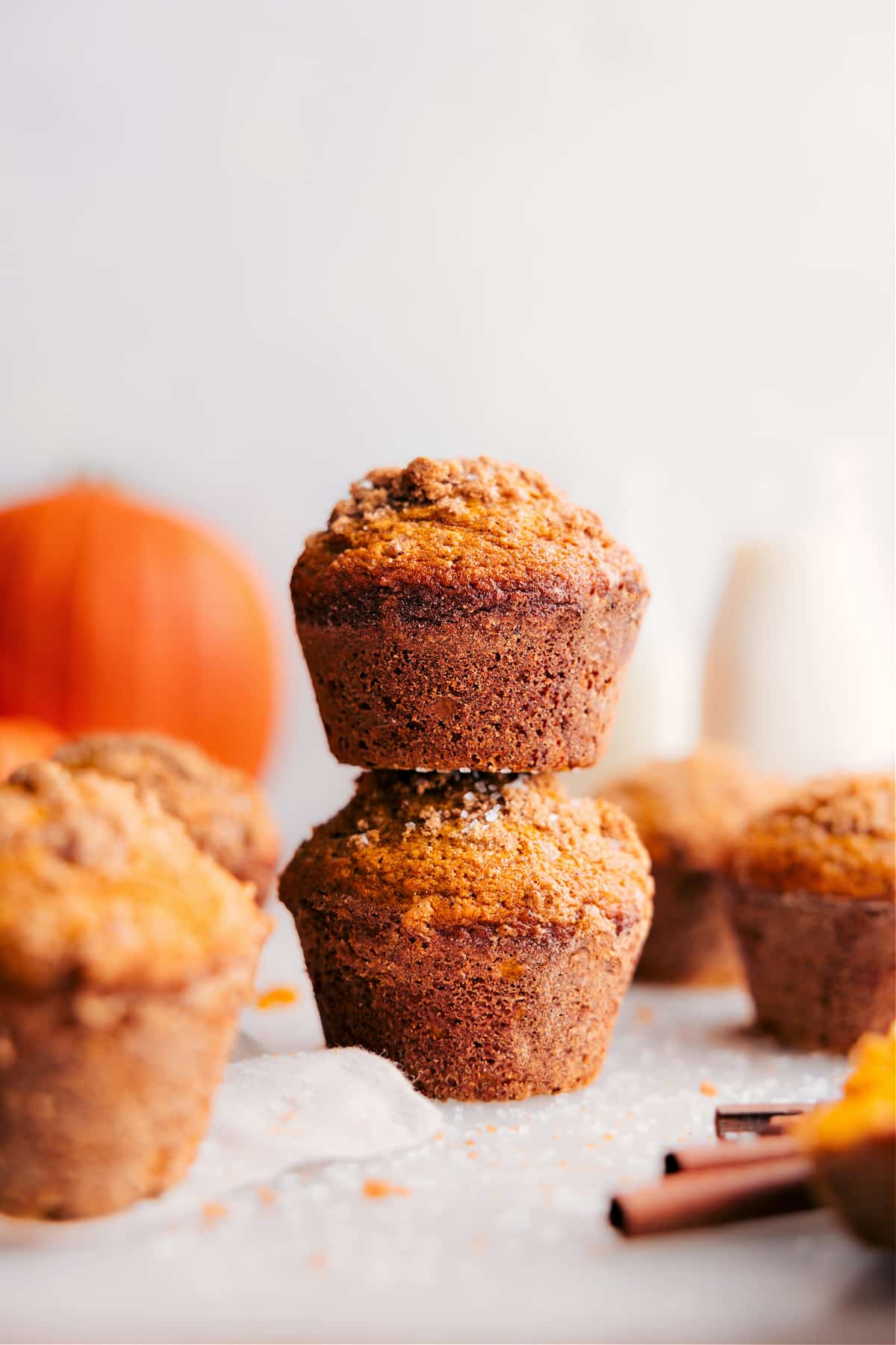A batch of freshly baked pumpkin muffins, golden and risen, straight from the oven.