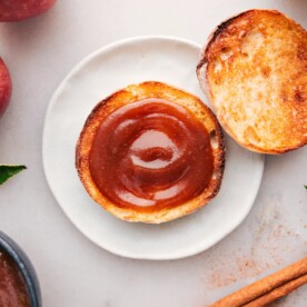 Thick spread of apple butter atop a golden slice of toast.