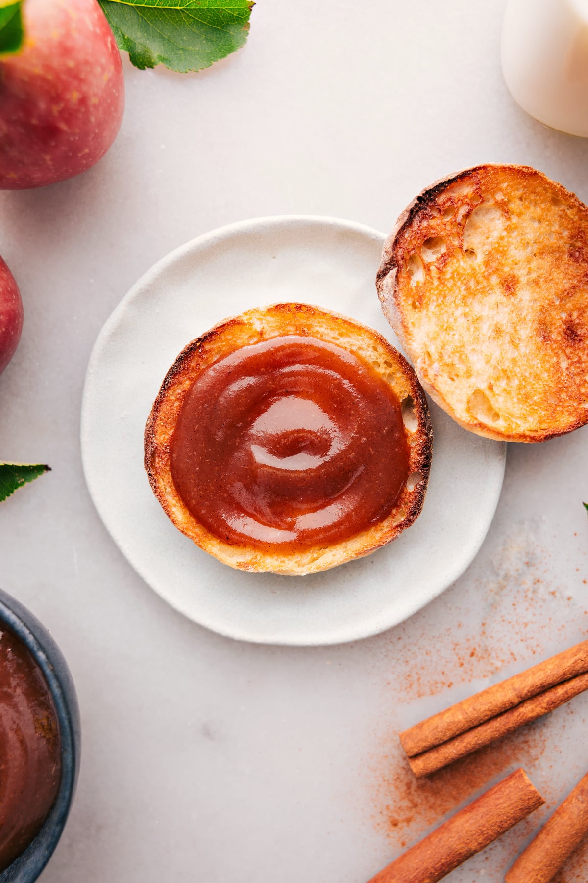 Thick spread of apple butter atop a golden slice of toast.