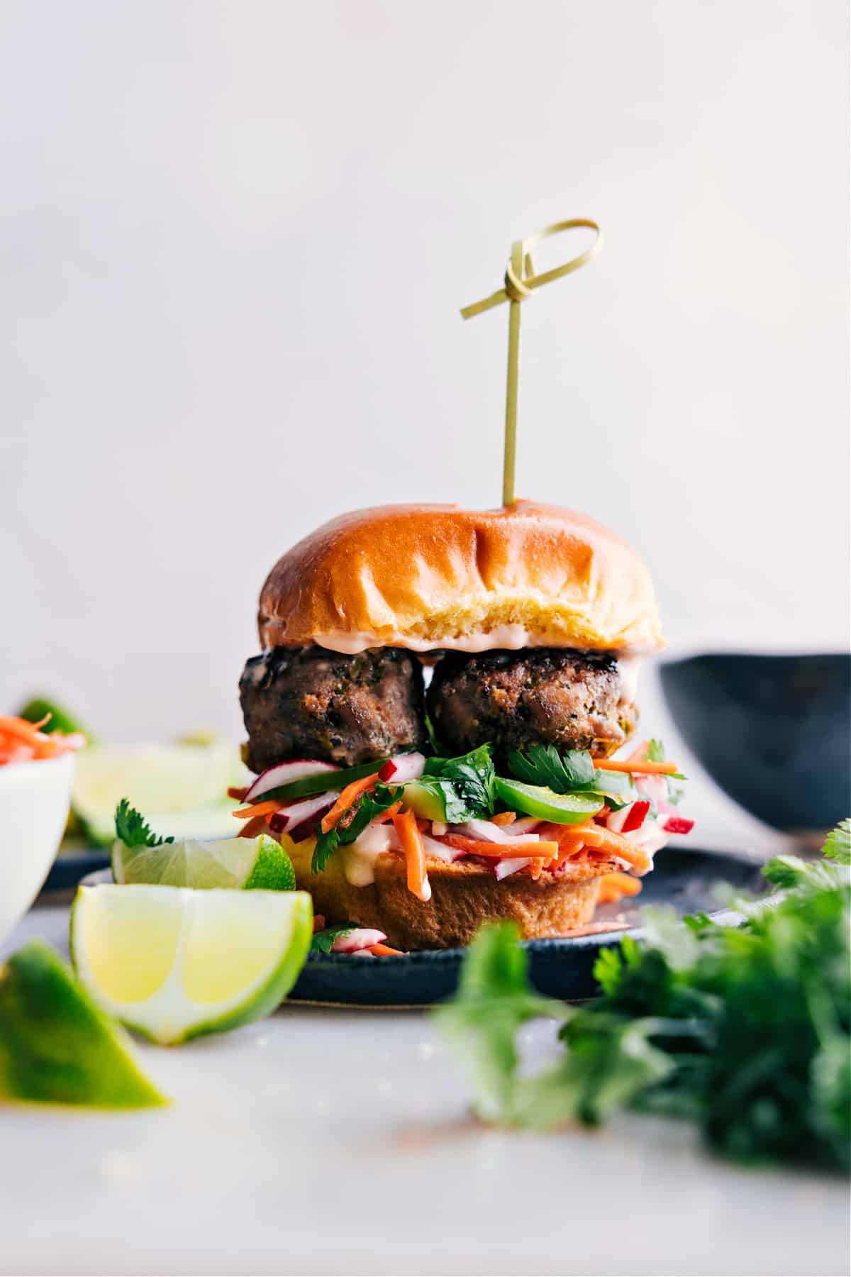 Mouth-watering slider brimming with succulent banh mi meatballs and crisp vegetables, fully assembled and ready to delight.