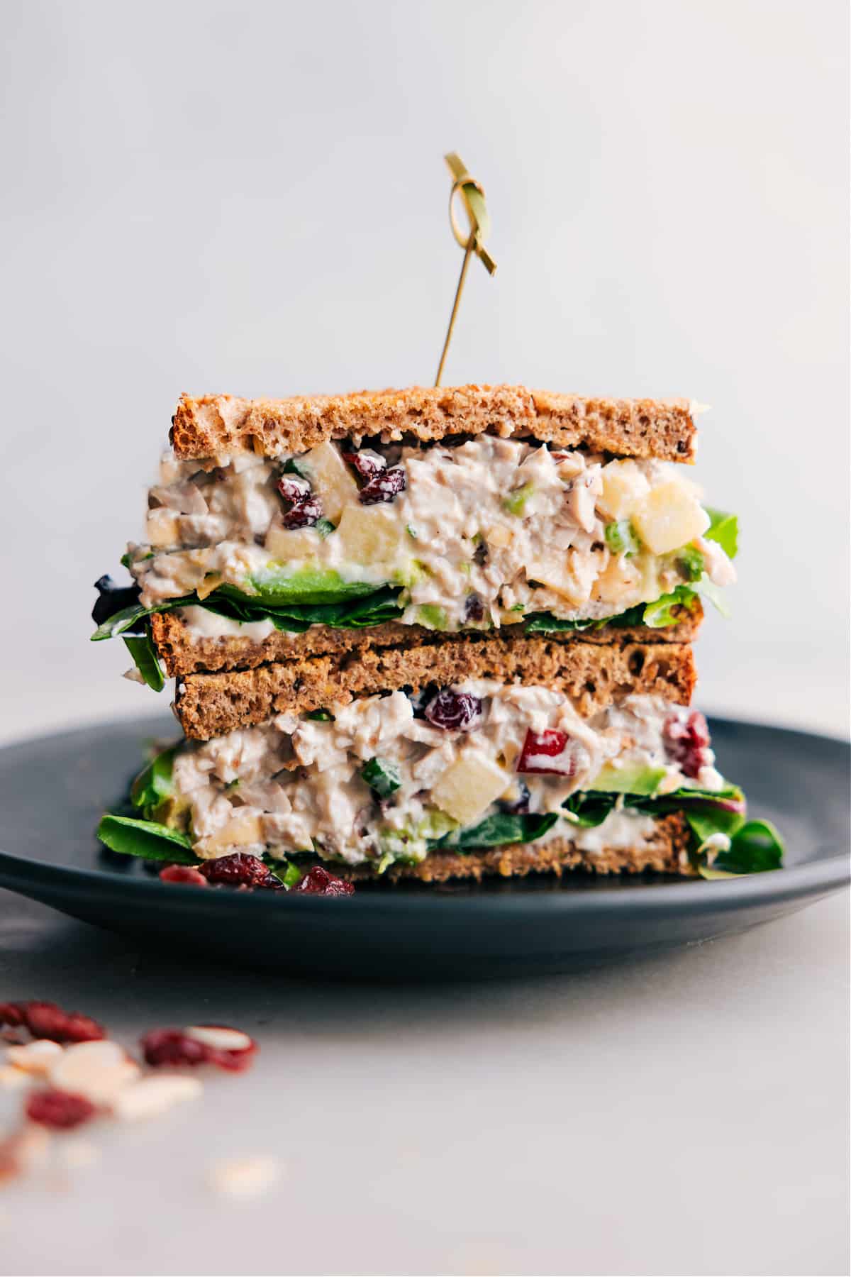 Stacked half-cut chicken salad with apples, showcasing the flavorful filling inside.