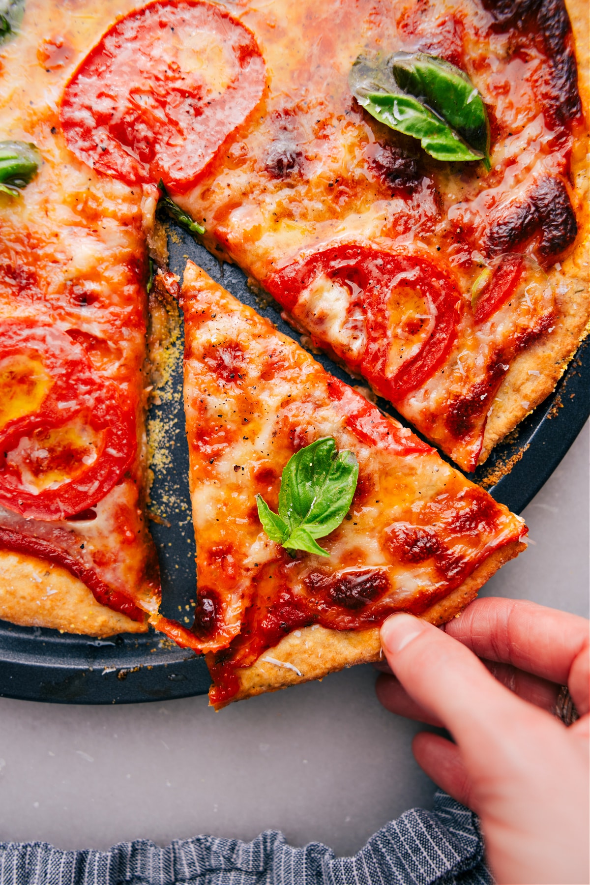 Freshly baked No-Yeast Pizza with a slice being lifted out.