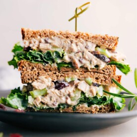 Scrumptious rosemary chicken salad sandwich, halved to reveal its generous, flavorful filling.