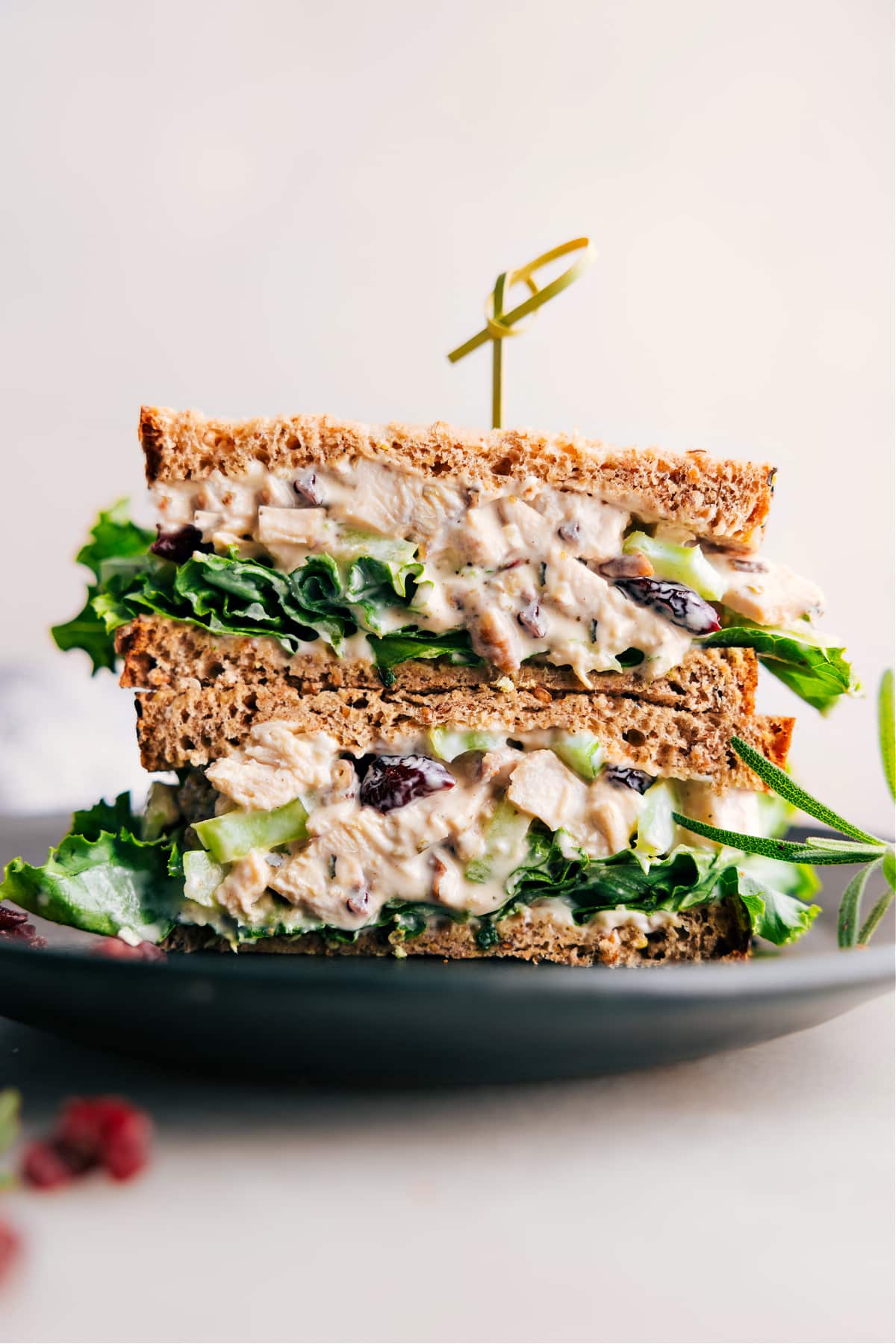 Scrumptious rosemary chicken salad sandwich, halved to reveal its generous, flavorful filling.