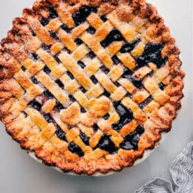 Freshly baked berry pie made with the best pie crust recipe, ready to be served.