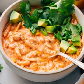 A big bowl of Buffalo Chicken Chili with a spoon in it.