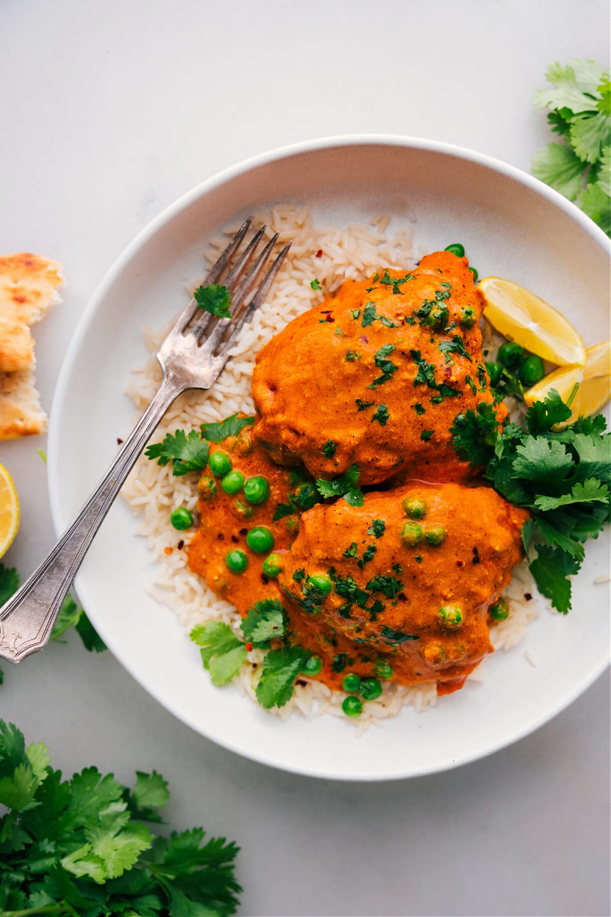 A finished Chicken Tikka Masala dish laid over a bed of rice, delicious, warm, and aromatic.