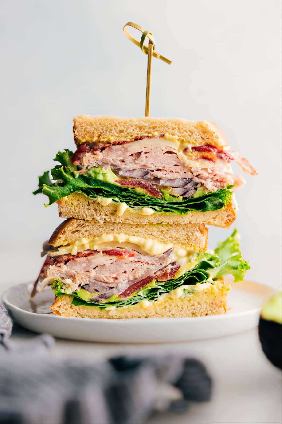 A thick and flavor-packed turkey bacon avocado sandwich made with delicious Thanksgiving leftovers, fresh vegetables, and a savory sauce.