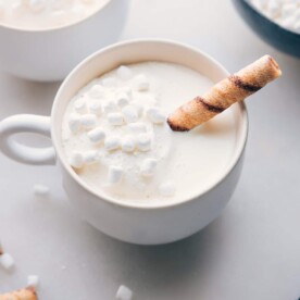 The finished white hot chocolate beverage in a mug, topped with mini marshmallows, a delicious and beautiful drink ready for enjoyment on a cold day.